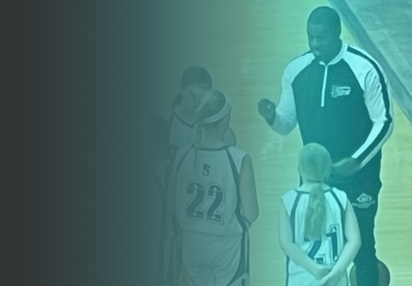 Coach Emery guiding young basketball athletes on the court